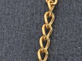 a close up of a gold chain with a lock on it