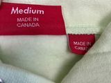 the label on a white shirt reads medium made in canada