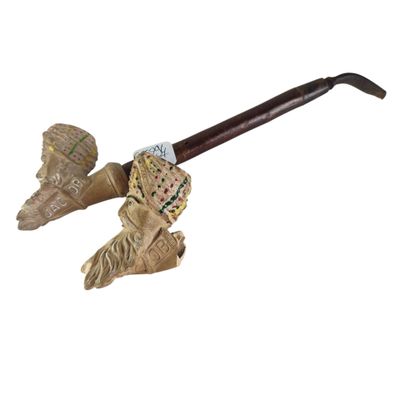 an image of a pipe with a wooden handle and a wooden handle