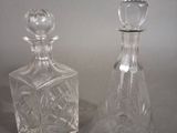 pair of crystal decanters on a table with a white background