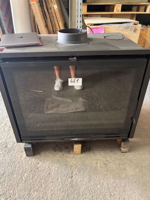 a person standing in front of a stove in a room