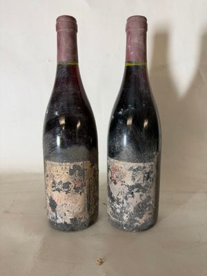 two bottles of wine sitting next to each other on a table