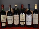 six bottles of wine are lined up in a row on a table