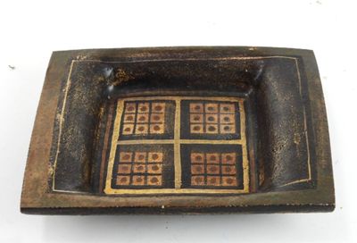 a brown and black bowl with squares on it