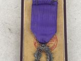 purple ribbon in a case with a dragon on it
