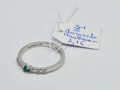 an image of a diamond and emerald ring with a price tag