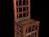 an old wooden chair with a wooden seat on a black background