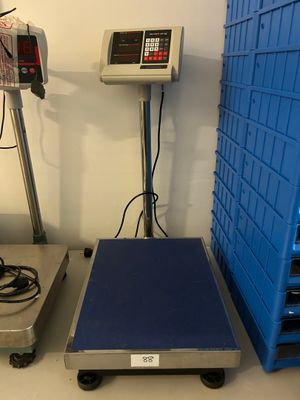 two weighing machines sitting next to each other on the floor