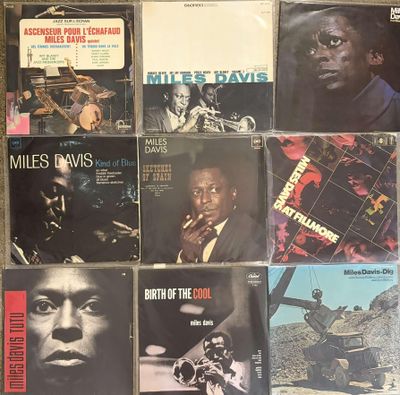 several records of miles davis are on display on a table