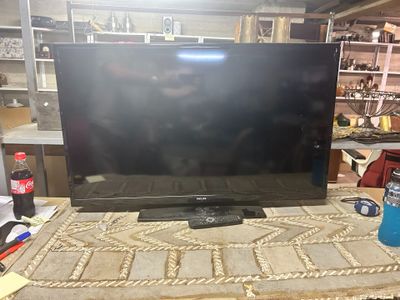 a flat screen tv sitting on top of a table