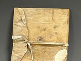 a small piece of paper wrapped around a piece of wood