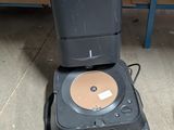 a cd player sitting on the floor next to a computer