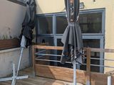 an umbrella that is on the deck of a building