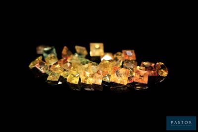 some very pretty colored crystals on a black surface