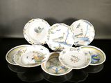 a group of plates and bowls on a black table