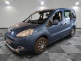 a picture of a small blue van parked in a garage