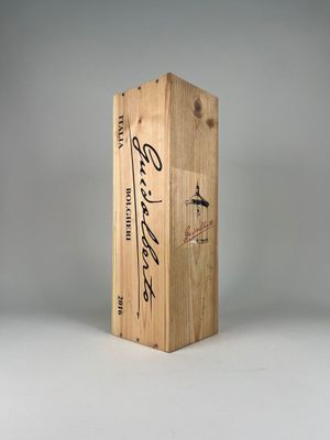 a close up of a wooden box on a white surface