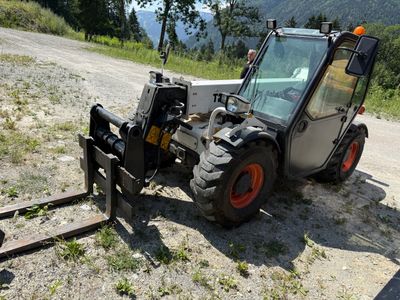 a small tractor that is parked on the side of the road