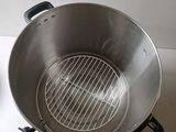 a large metal pot with a grill inside of it