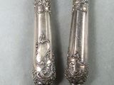 pair of antique silver plated candlesticks with gold accents