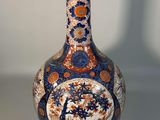 a vase sitting on a table with a white background