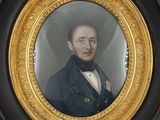 portrait of a man in a black coat and bow tie in a gold frame