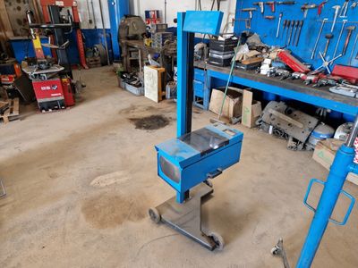 a blue workbench in a garage with tools on it