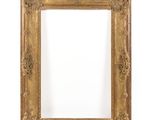 a gold frame with a white background and a white wall