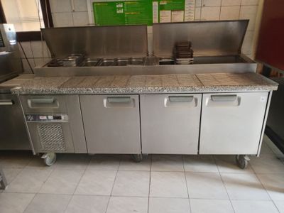 a kitchen with a sink, stove, and refrigerator in it