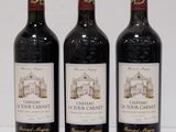 three bottles of wine sitting on top of a white table