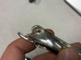a person holding a small metal object in their hand