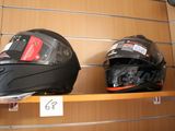 two helmets that are on a shelf in a store