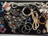a black box filled with lots of jewelry on a table