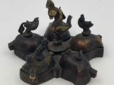 bronze figurine of a boy on a horse with birds on his back