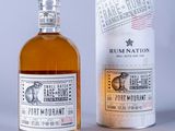 a bottle of rum nation next to a can of rum nation