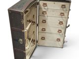 an old suitcase with many drawers inside of it