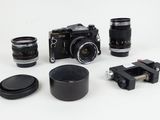 a lot of different cameras and lenses on a white surface