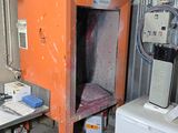 a small orange cabinet in the corner of a room