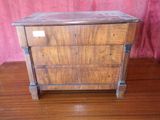 a small wooden chest of drawers on a wooden table