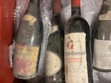 several bottles of wine are in a red box on a table