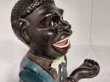 a small statue of a man with his hands up