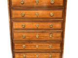 a wooden chest of drawers with brass handles and brass hardware