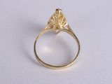 a close up of a gold ring with a diamond in the center