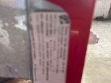 a red fire hydrant with a sign on the side of it