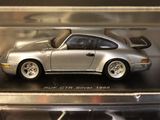 a silver model of a car in a display case