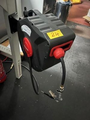 an image of a red and black fire hydrant in a garage