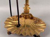 a gold candle holder with two candles on it
