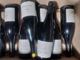 six bottles of wine in a box on the table