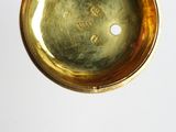 a person holding a gold pocket watch in their hand