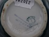 a close up of a vase with a tag on it
